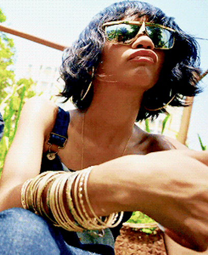 Celebrity gif. Zendaya poses at us from an angle set at the ground.