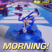 Sponsored gif. Sonic the Hedgehog uses one hand to balance in the air on the steering wheel of his race car as he drives before flipping back into the driver’s seat. Text reads, “Morning!”
