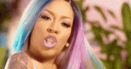 Celebrity gif. K Michelle looks at us with a serious expression and points directly at us.