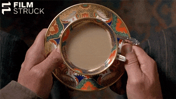 Movie gif. From The Piano, we are looking down from the perspective of someone holding a decorative teacup, stirring it with a spoon.