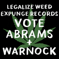 Digital art gif. Green marijuana leaf on a black background with a message in white marker font, "Legalize weed, expunge records, Vote Abrams and Warnock."