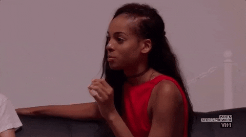 Reality TV gif. A contestant on America's Next Top Model raises eyebrows and opens up her hand in a gesture to "go ahead."
