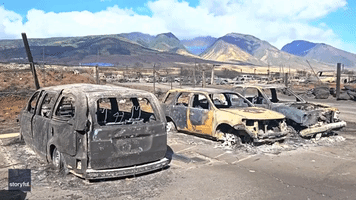 Rainbow Appears Behind Line of Scorched Cars in Maui