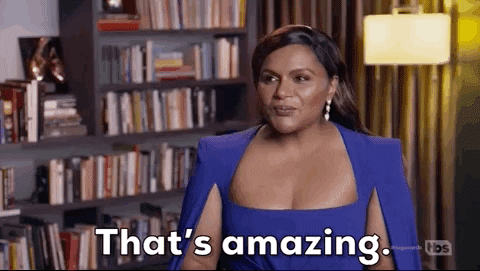 Celebrity gif. Mindy Kaling, sitting for an interview, raises her palms in front of her and says, "That's amazing," which appears as text.