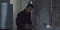 TV gif. Julian McMahon as Jess LaCroix on FBI: Most Wanted walks into a room while looking down at an open file. He looks up and smiles while saying, “Hey, hey! Look who it is!”