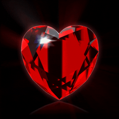 Digital art gif. Red diamond shaped like a heart spins around in a circle.