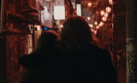 Music video gif. From Eden's video for "Sex," we follow a couple ambling down an illuminated street at night, one person with his arm around the other.