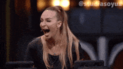 Video gif. Woman wearing a headset microphone laughs with her mouth gaping open as she tilts forward.