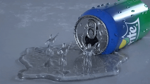 Ad gif. A can of sprite lies on its side, soda spilling out onto the floor creating a growing puddle. Three dancing figures made out of the soda twirl in the soda, making eddies as they spin and rock back and forth with arms raised. 