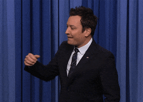 Tonight show gif. Jimmy Fallon does a low fist pump and bites his lip in excitement.