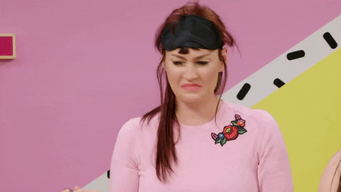 TV gif. Mamrie Hart, a host on This Might Get... shakes her head and frowns deeply as she holds a spoonful of something and talks to someone off screen.