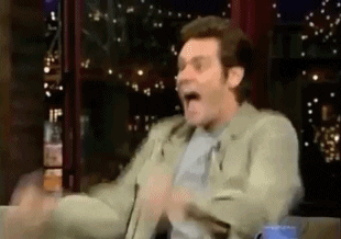 Celebrity gif. Jim Carrey pumps his fist in celebration on a late night show, then pulls confetti from his pocket and throws it everywhere. Next he blows on a kazoo then drinks from a mug and spits it out forcefully and shakes hands with the host. Then he runs to the camera and spins around with it, then runs into the audience, grabs a woman, and pretends to make out with her. Then he finds a man in the audience, pretends to kiss him on the ground, then runs to hug someone else, then back to the man and kisses him again.