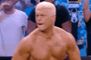 TV gif. American professional wrestler Cody Rhodes screams and beats his chest inside the wrestling ring so furiously that his neck veins bulge. He's getting the crowd fired up. Text, "Let's gol!!!!"