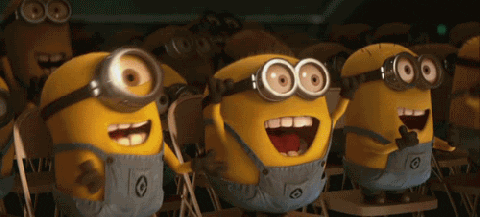 Movie gif. An audience of deliriously ecstatic minions from Despicable Me cheer with their hands in the air.