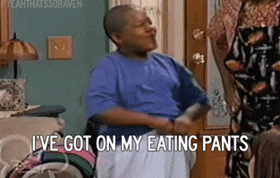 TV gif. Kyle Massey as Cory Baxter on That’s So Raven stretches out his oversized sweatpants with a big, proud smile on his face as he says, “I've got my eating pants.”