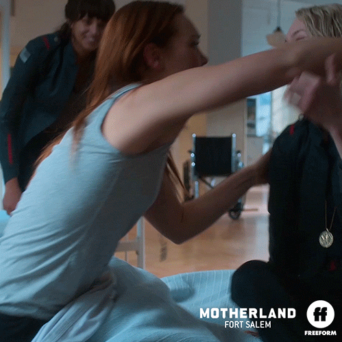 Three women are hugging each other.