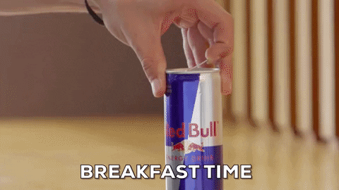 Ad gif. A man pops open a can of Red Bull and chugs it. Text, “Breakfast Time.”