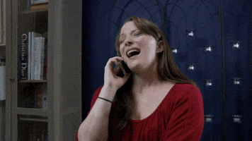 Video gif. Woman writhes uncomfortably while talking on her cell phone, saying, "I was really drunk," which appears as text.