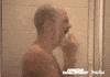 TV gif. Side view of David Cross as Tobias in Arrested Development sobbing uncontrollably into a washcloth in the shower.