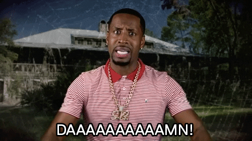 Video gif. Safaree Samuels throws his hands out in front of him and inspects his arms while shocked, saying “DAAAAAAAAAAMN!” the background a spiderweb overlaid on a mansion.