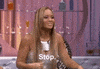 Reality TV gif. Evelyn Lozada on Basketball Wives tilts her head to the side and flashes her hands in front of her as she says, "stop," which appears as text.
