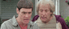Movie gif. Actors Jim Carrey and Jeff Daniels in Dumb and Dumber both turn to look at something out of frame with confusion.