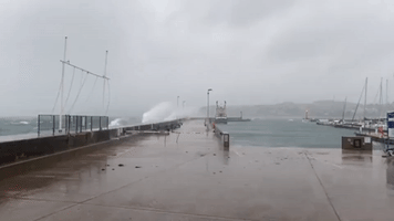 Waves Crash Over Torquay Harbour Amid Storm Barra