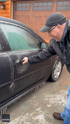 Man Slips and Slides Trying to Open Frozen Car Door After Ice Storm Hits North Dakota