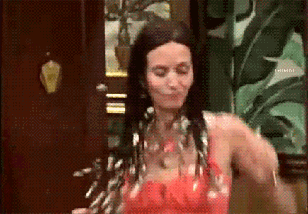 Friends gif. Courteney Cox as Monica Geller dances energetically with her shoulders while her beaded braids flail around just as wildly.