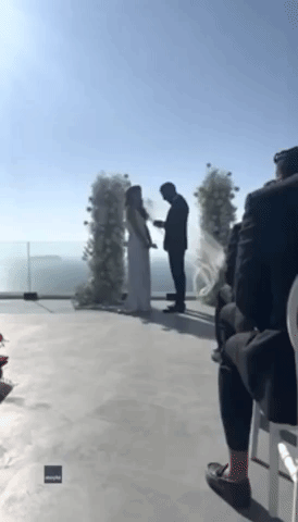 'I Don't Need It!': Wind Whips Veil From Bride's Head During Santorini Wedding Ceremony