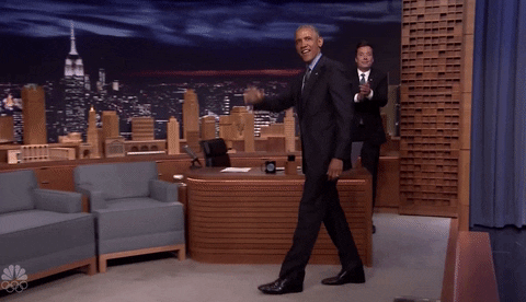 Political gif. President Barak Obama waves at the audience from the stage of The Tonight Show as Jimmy Fallon points and claps enthusiastically.