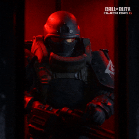 Sponsored gif. Elevator doors open to reveal a person in full combat gear. 