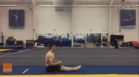 Gymnast Effortlessly Executes Sitting Back Flip