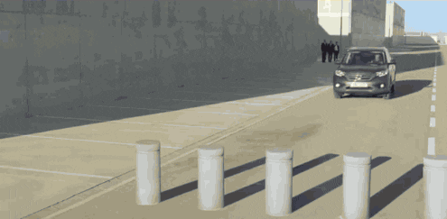 Ad gif. Gray Honda CR-V appears to drive over three cement pillar barriers, then the image stretches and appears to reverse.