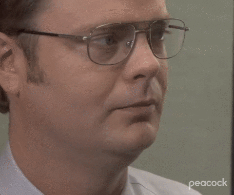 The Office gif. Rainn Wilson as Dwight swallows hard as his eyes dart back and forth and he slowly lowers his head as if sad. 