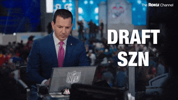 Sports gif. Ian Rapoport, a sports reporter, looks up from his laptop with an excited expression and claps his hand. He says, "The pick is in!'