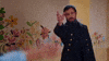 TV gif. In a scene from At Home with Amy Sedaris, Justin Theroux as the sea captain slides away dramatically with an arm outstretched, while another outstretched arm in the foreground reaches out to him.