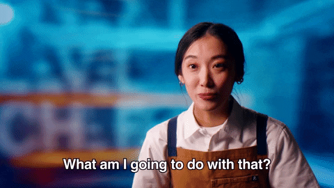 Reality TV gif. A contestant on Next Level Chef is in an interview and she smiles blankly, blinking quickly as she asks, "What am I going to do with that?"