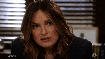 TV gif. Mariska Hargitay as Olivia Benson on Law and Order SVU leans forward on her desk and looks forward with a disappointed expression. She hides her face with both of her hands, looking down towards the desk.