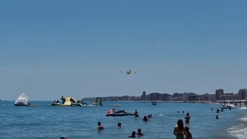 Airplane Swoops Down on Spanish Beach to Collect Water to Fight Wildfire