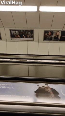 Tilted Escalator Riders in Budapest
