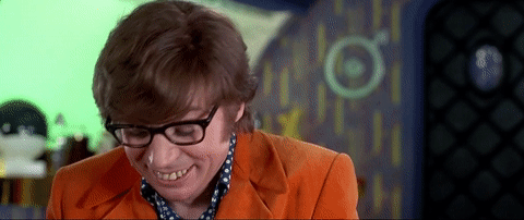 Movie gif. Mike Myers as Austin Powers looks up and smiles goofy while saying "Sex? Yes please!" which appears as text.