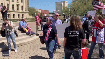 Anti-Lockdown Protester Challenges Health Care Workers Outside Kansas State Capitol Building