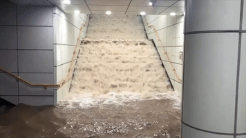Water Pours Down Stairs in Seoul Subway Station During Historic Flooding