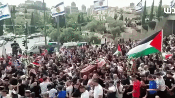 Israeli Flags Pulled Down as Slain Palestinian Journalist's Funeral Procession Moves Through Jerusalem