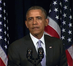 Politics gif. Barack Obama behind a microphone, taken aback, frowning slightly and turning his hand up as if to say, "what?"