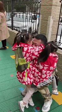 Chinese Man Lifts His Four-Year-Old Triplets After