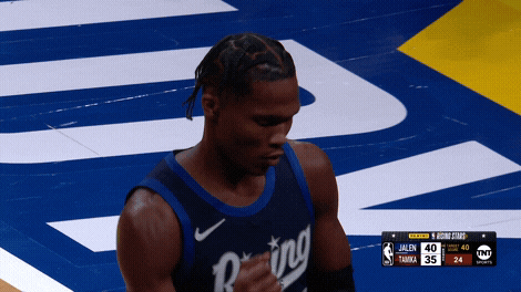 Sports gif.  Ben Mathurin, a player for the Indiana Pacers, does a quick, pared down version of the dougie as he celebrates on the court.