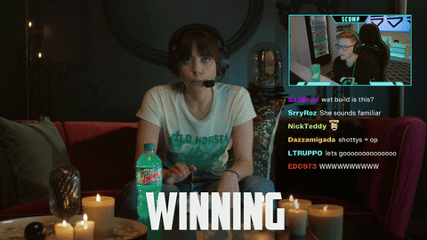 Sponsored gif. Aubrey Plaza wears a gamer headset and presses a key repeatedly on her keyboard with a Mountain Dew Baja Blast sitting next to it. She's in the middle of streaming with another gamer, whose video box is picture in picture on the top right while a bunch of comments pour in below it. She's locked in, unblinking as she repeatedly says, "Winning."