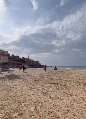 Beachgoers Run for Cover as Sirens Go Off in Tel Aviv